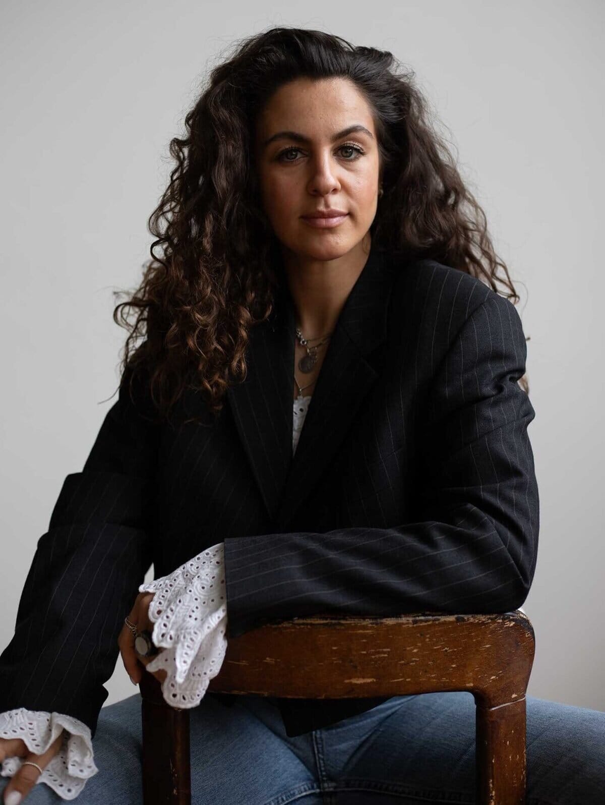 Owner Olivia Chouchane sitting on Bruno Ray chair